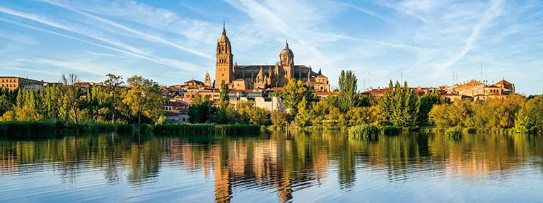 Salamanca Cathedral towering over River Tormes in Spain
